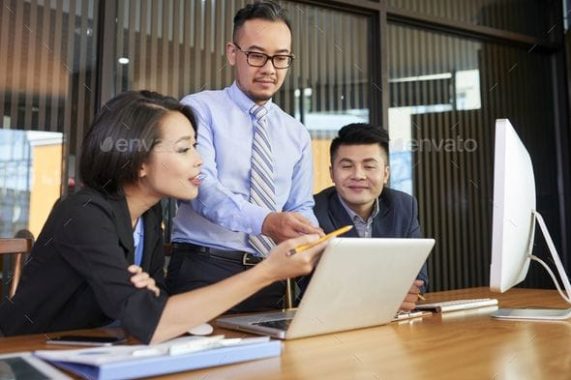 Colleagues Working Together by DragonImages_ Group…